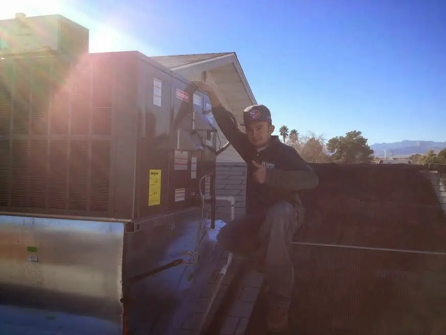 HVAC technician performing HVAC Inspection on a rooftop unit in West Monroe